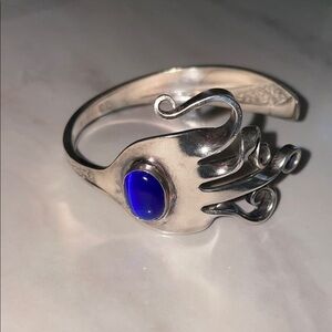 Artistic Silver Bracelet with Deep Blue Accent